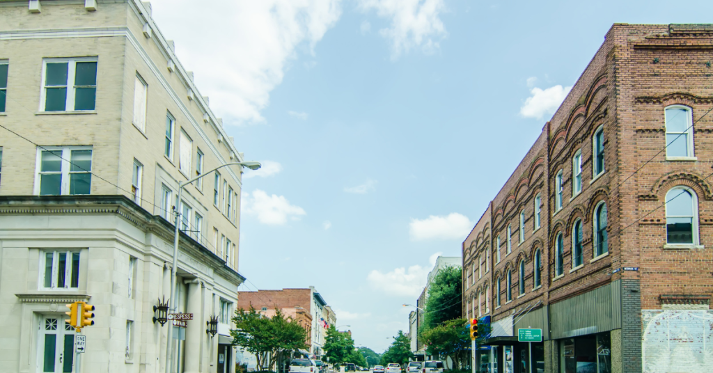 downtown street with businesses and homes